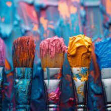 six colorful paintbrushes in a row